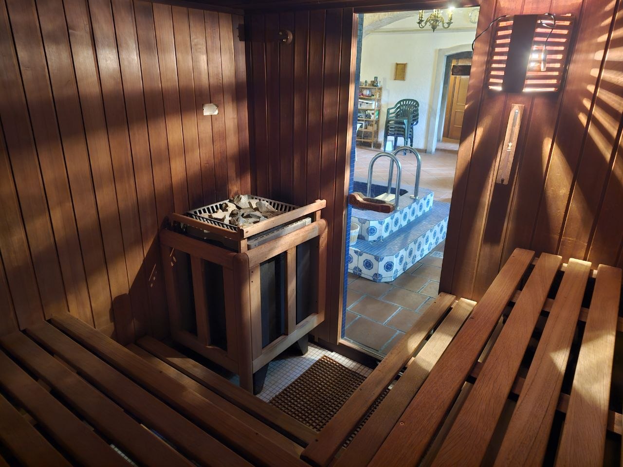 Innenraum der Stammsauna mit Klafs-Saunaofen und Blick in den Baderaum